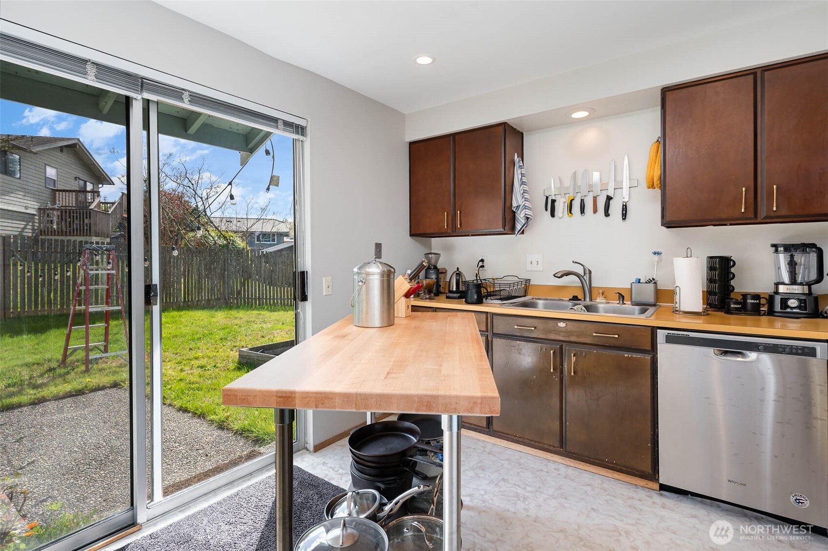 2107 Southeast 21st Court Renton, WA 98055 - Photo 7 of 28 a kitchen with a table chairs refrigerator and sink