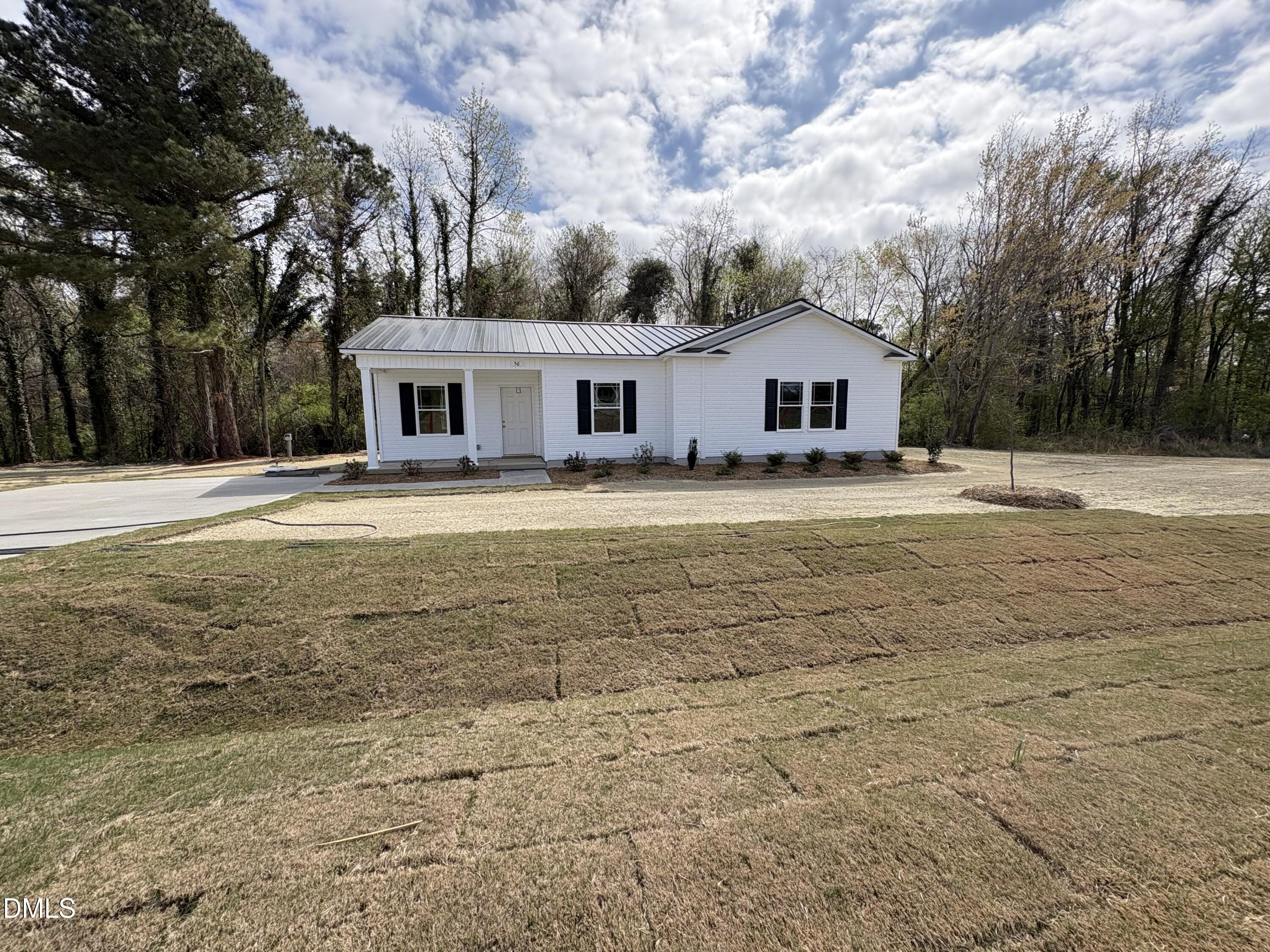 56 Jacobs Ridge Drive Four Oaks, NC 27524 - Photo 1 of 17 a front view of house with yard and trees