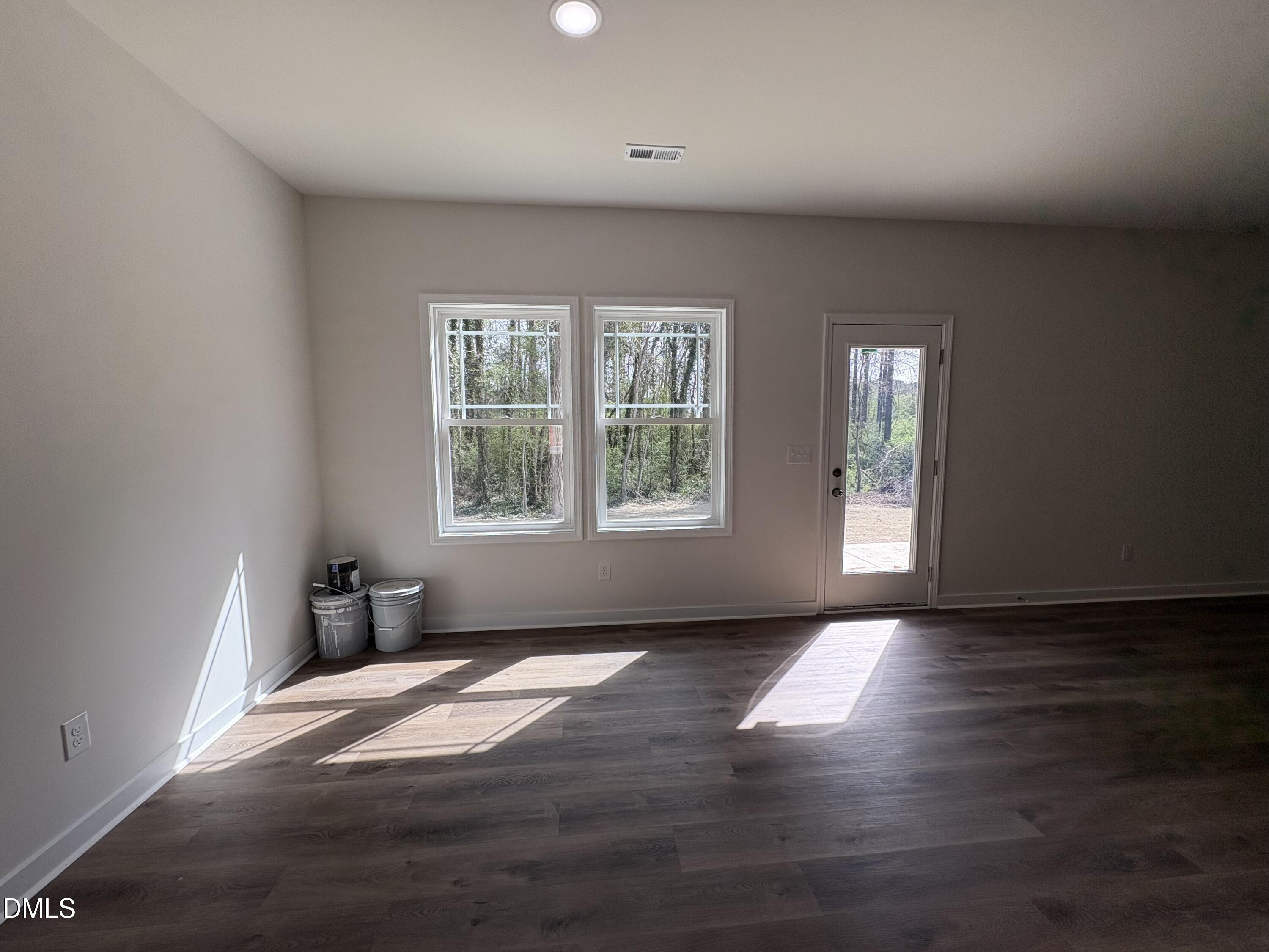56 Jacobs Ridge Drive Four Oaks, NC 27524 - Photo 7 of 17 an empty room with wooden floor and windows