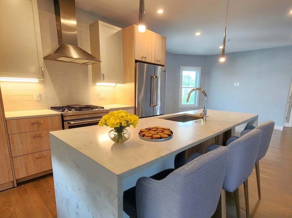 84 Romsey Street, Unit 3 Boston, MA 02125 - Photo 1 of 20 a kitchen with stainless steel appliances granite countertop a sink a refrigerator and a stove