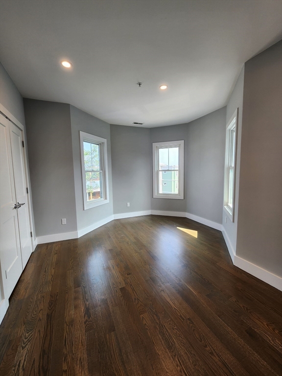 84 Romsey Street, Unit 3 Boston, MA 02125 - Photo 11 of 20 a view of empty room with window and wooden floor