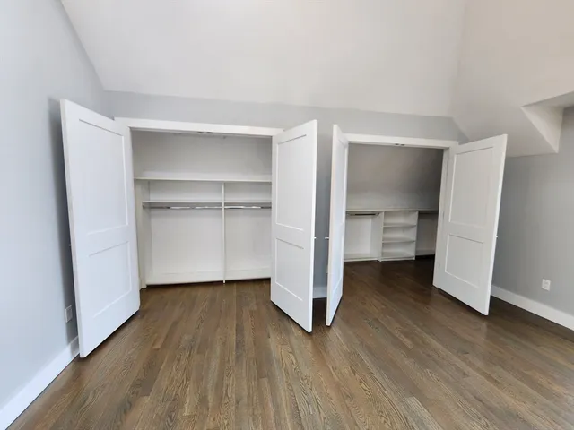 a view of a room with wooden floor and closet