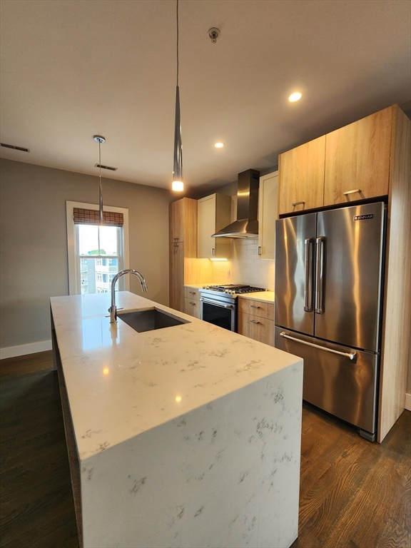 84 Romsey Street, Unit 3 Boston, MA 02125 - Photo 3 of 20 a kitchen with refrigerator and wooden floor