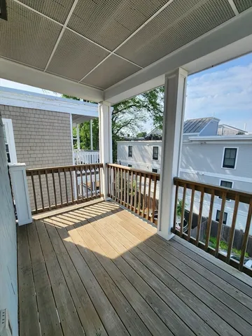 a balcony with wooden floor