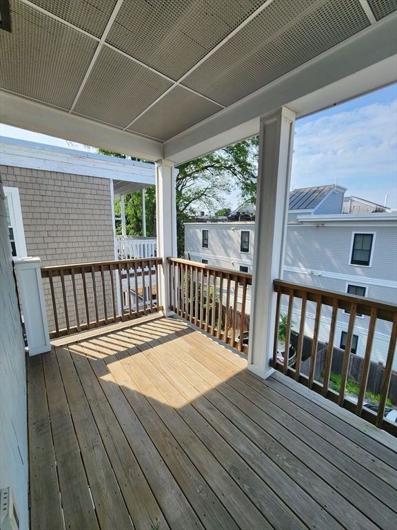 84 Romsey Street, Unit 3 Boston, MA 02125 - Photo 8 of 20 a balcony with wooden floor