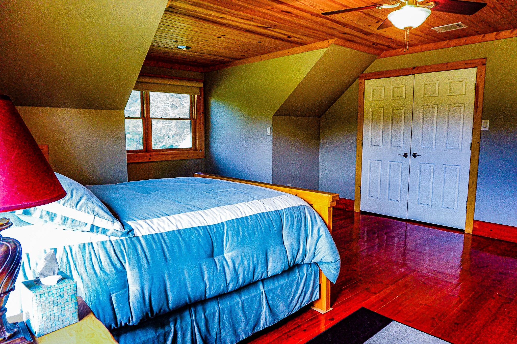 8786 Highway 75 Huntsville, TX 77340 - Photo 26 of 40 a bedroom with a bed and wooden floor