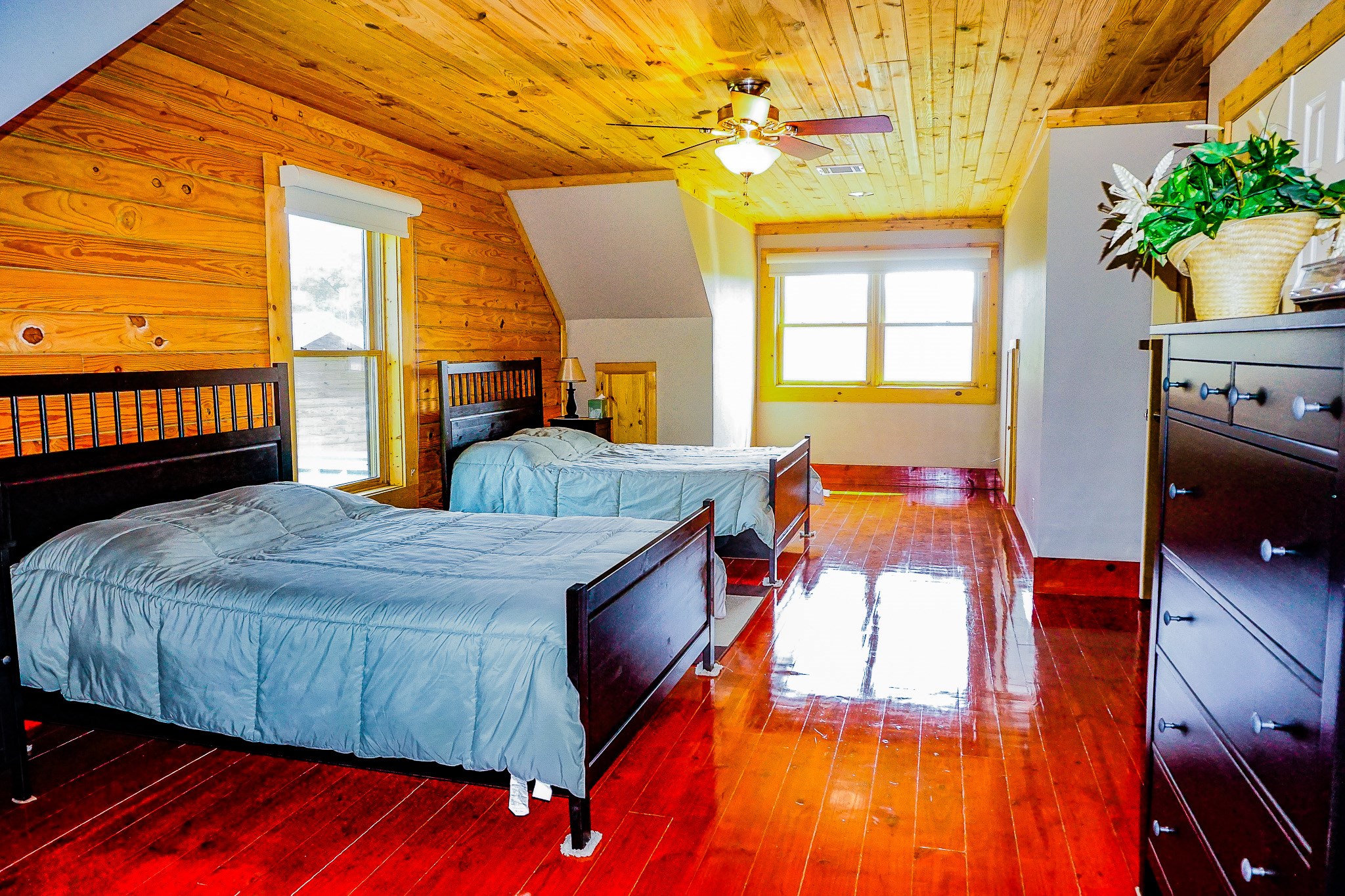 8786 Highway 75 Huntsville, TX 77340 - Photo 27 of 40 a bedroom with a bed and wooden floor