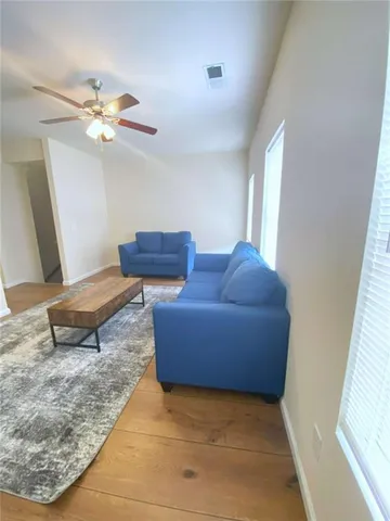 a living room with furniture and a rug