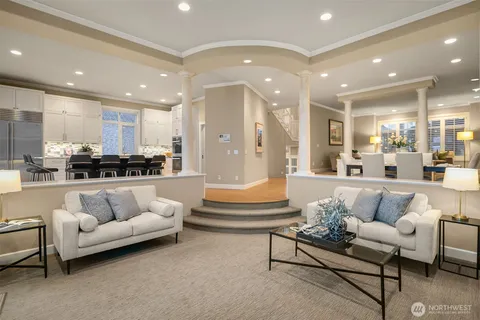 a living room with furniture and kitchen view