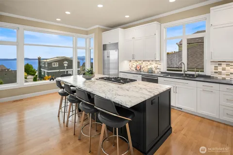 a kitchen with a table chairs stove and cabinets