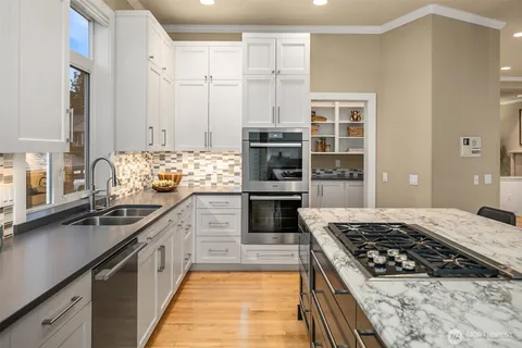 a kitchen with stainless steel appliances granite countertop a stove and a sink