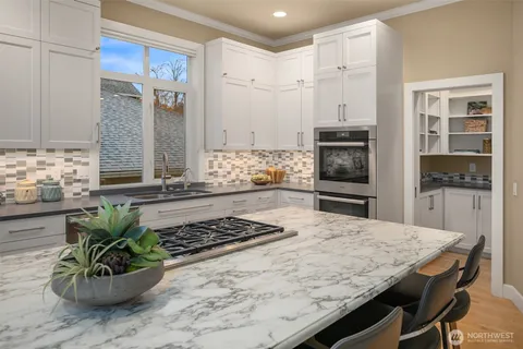 a kitchen with a table and chairs in it
