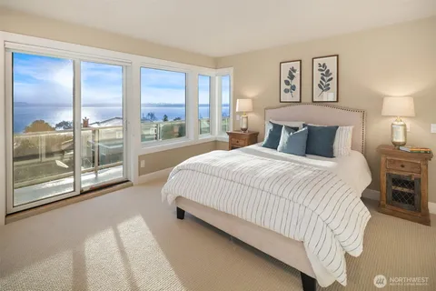 a spacious bedroom with a large bed and a large window