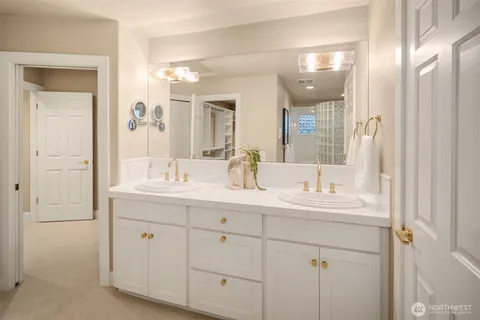 a bathroom with a double vanity sink mirror and