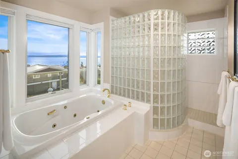 a bathroom with a bathtub and a shower