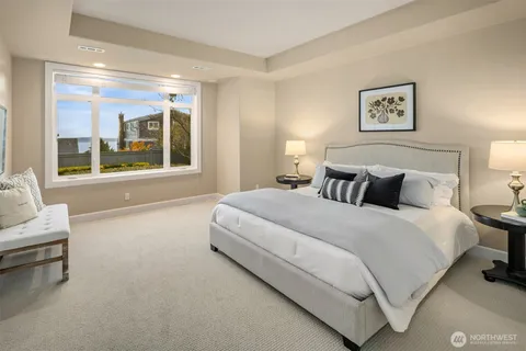 a bedroom with bed and large window