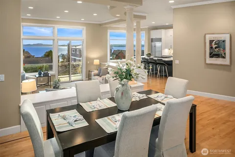 a dining room with furniture a large window and a chandelier