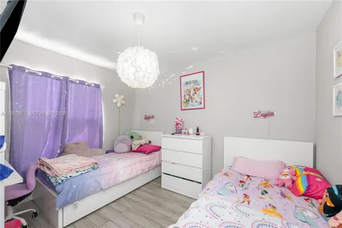 a bedroom with a bed and chandelier