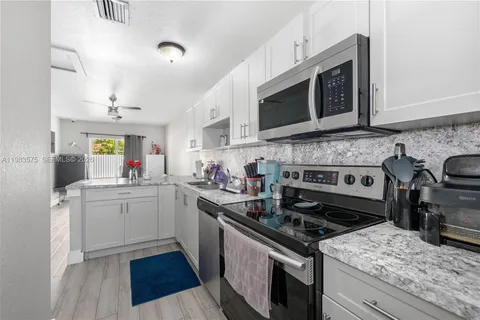 a kitchen with a stove and a microwave