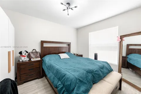 a bedroom with a bed a couch and dresser