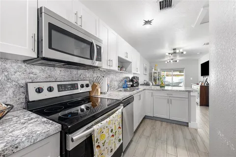 a kitchen with a stove and a microwave