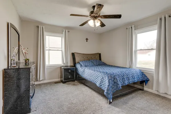 a bedroom with a bed and a chandelier