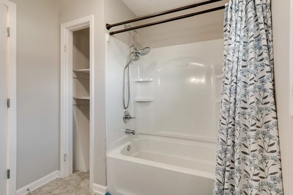 a bathroom with a shower and a bath tub