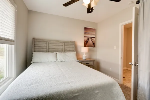 a bedroom with a large bed and a window