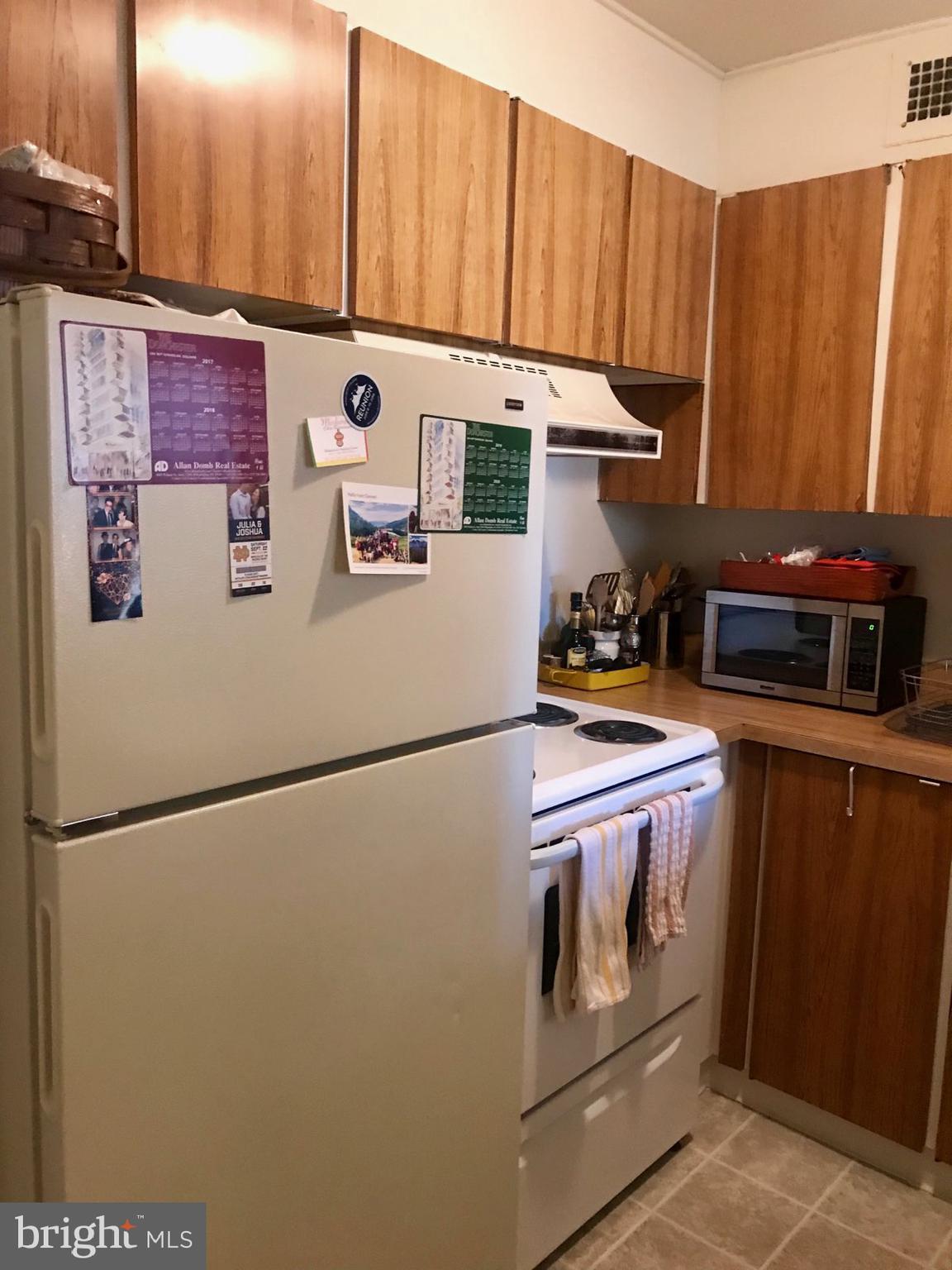 226 West Rittenhouse Square, Unit 307 Philadelphia, PA 19103 - Photo 2 of 18 a kitchen with stainless steel appliances a refrigerator and a stove