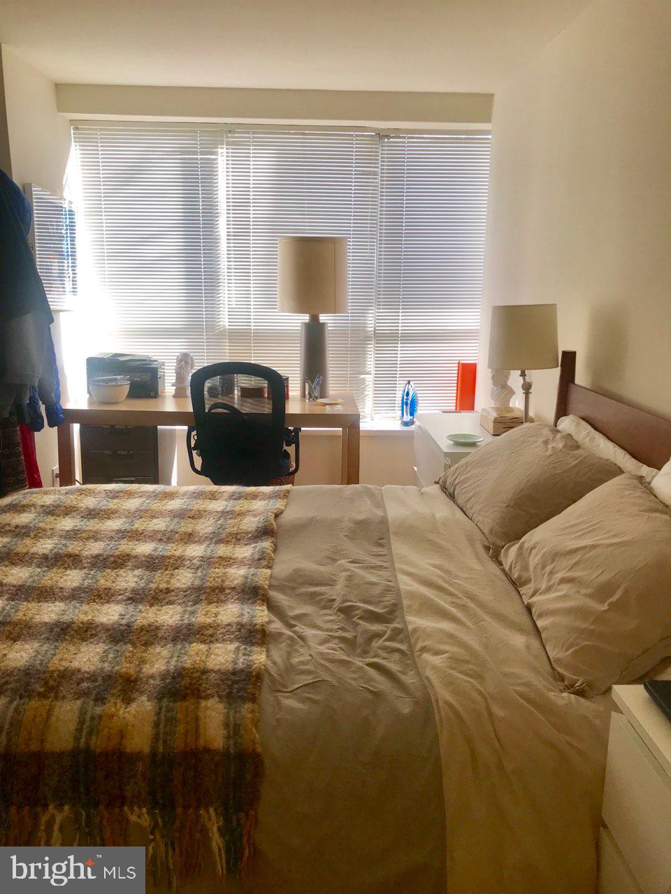 226 West Rittenhouse Square, Unit 307 Philadelphia, PA 19103 - Photo 6 of 18 a bedroom with a bed and a large window