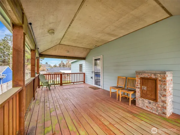 a view of a chairs and table on the wooden deck