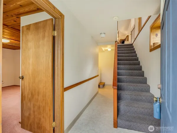 a view of entryway and hall with wooden floor