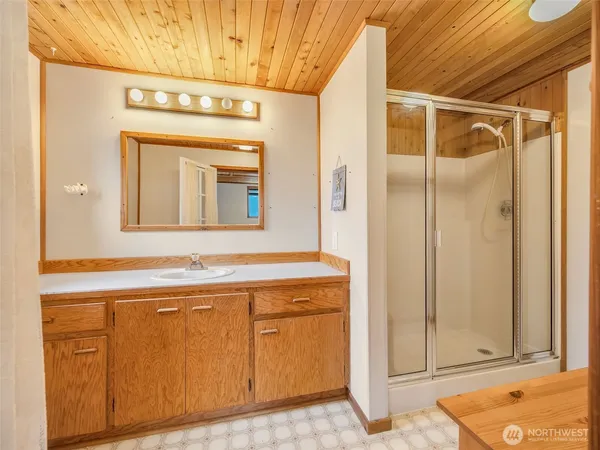 a bathroom with a sink a mirror and a shower