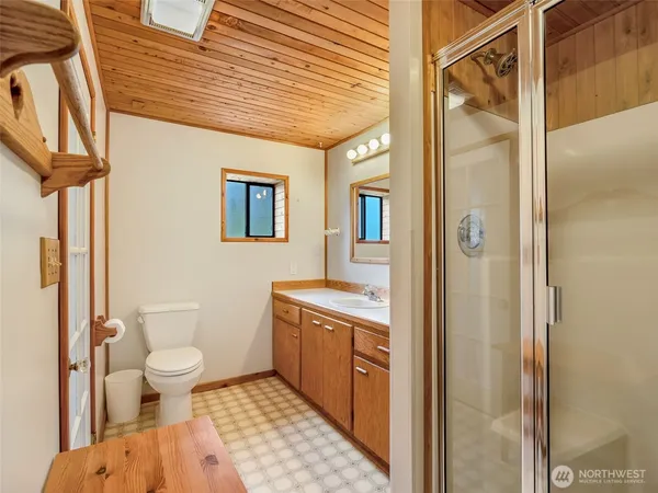 a spacious bathroom with a shower and a toilet