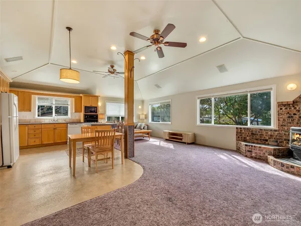 a view of a livingroom with furniture window and a kitchen view