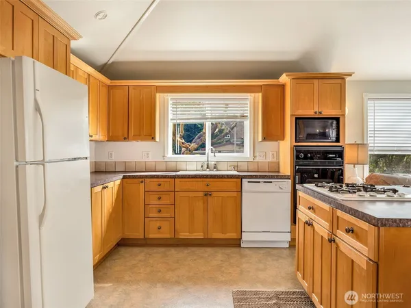 a kitchen with stainless steel appliances a refrigerator stove and sink