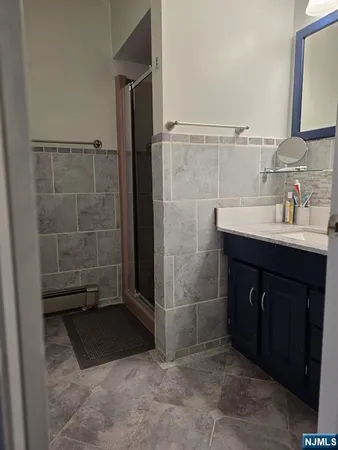 a bathroom with a sink a toilet and mirror