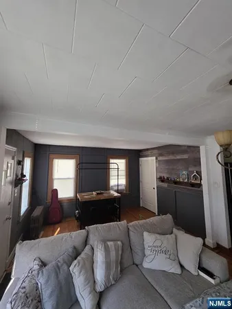 a living room with furniture and a mirror