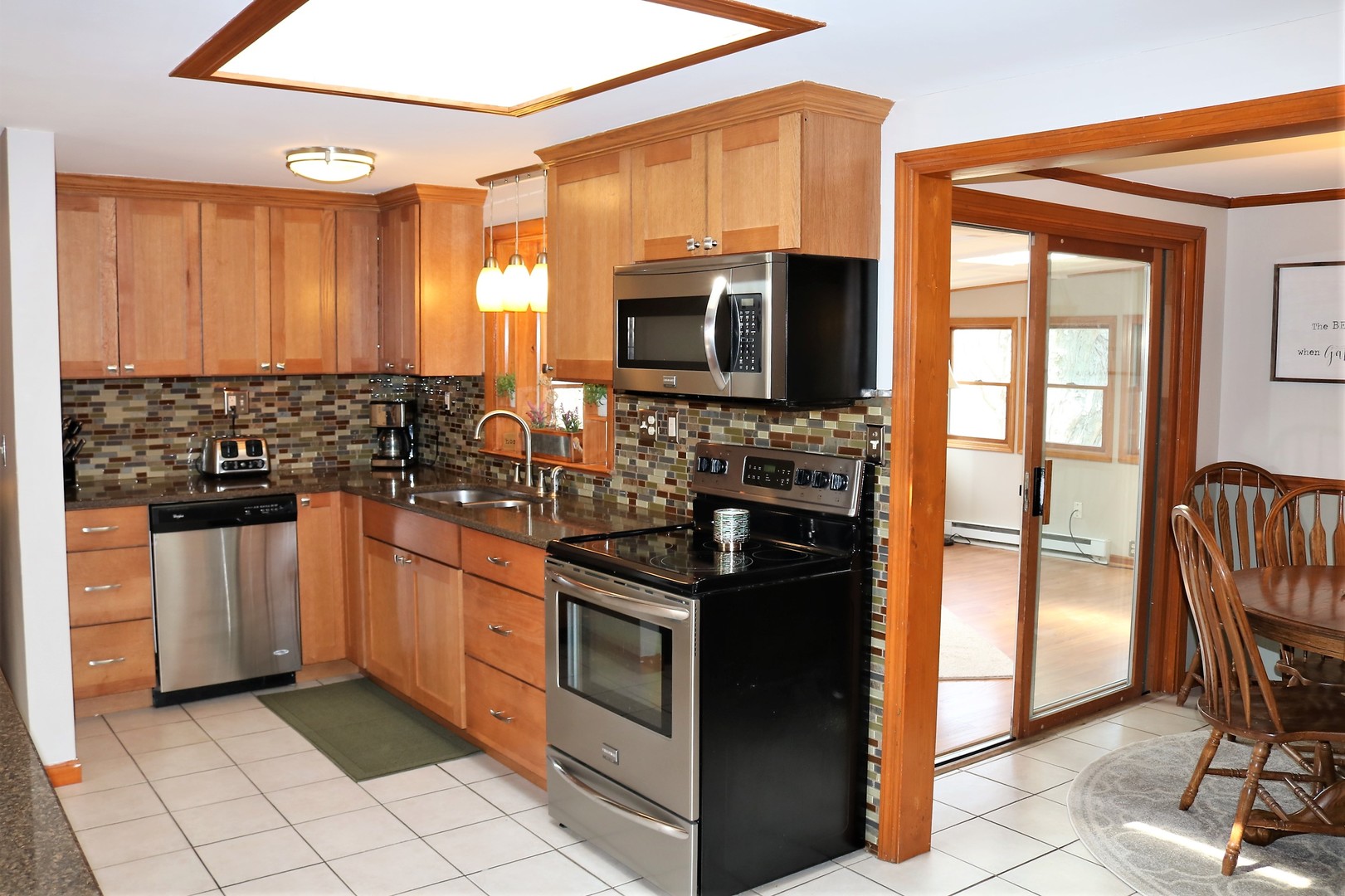 10167 Rich Road DeKalb, IL 60115 - Photo 6 of 31 a kitchen with stainless steel appliances granite countertop a stove a sink and a refrigerator