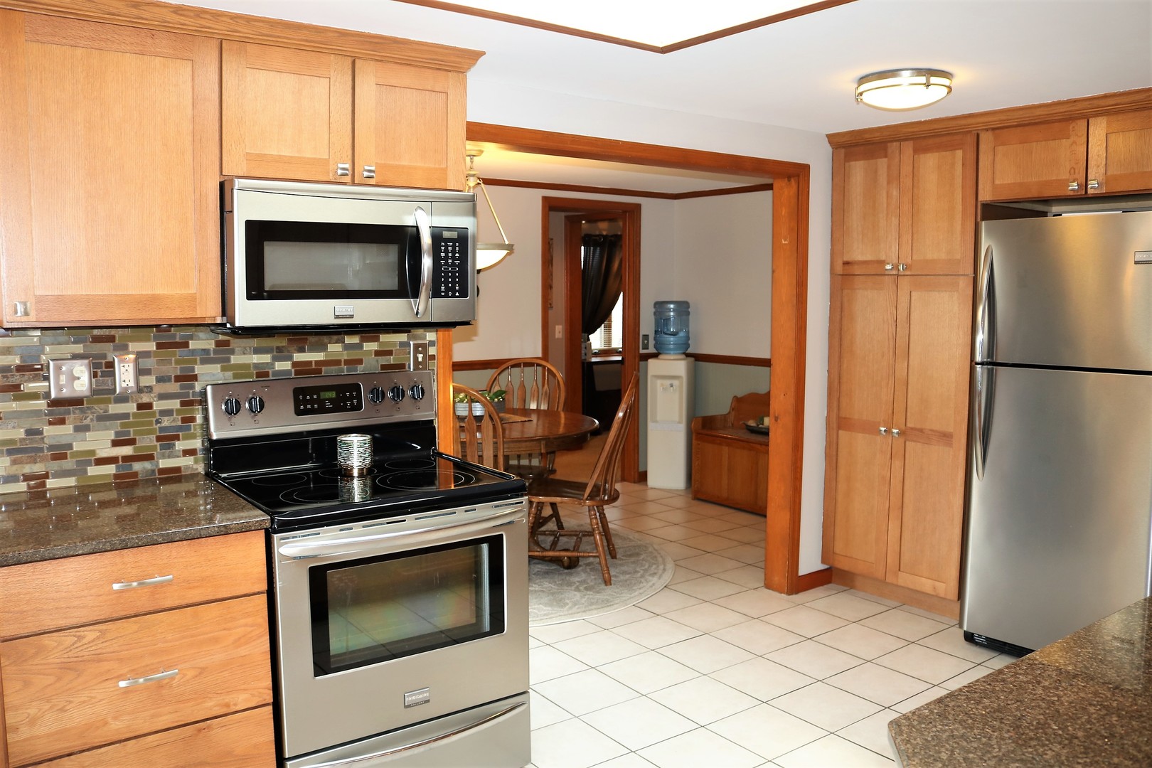 10167 Rich Road DeKalb, IL 60115 - Photo 7 of 31 a kitchen with a refrigerator stove and microwave
