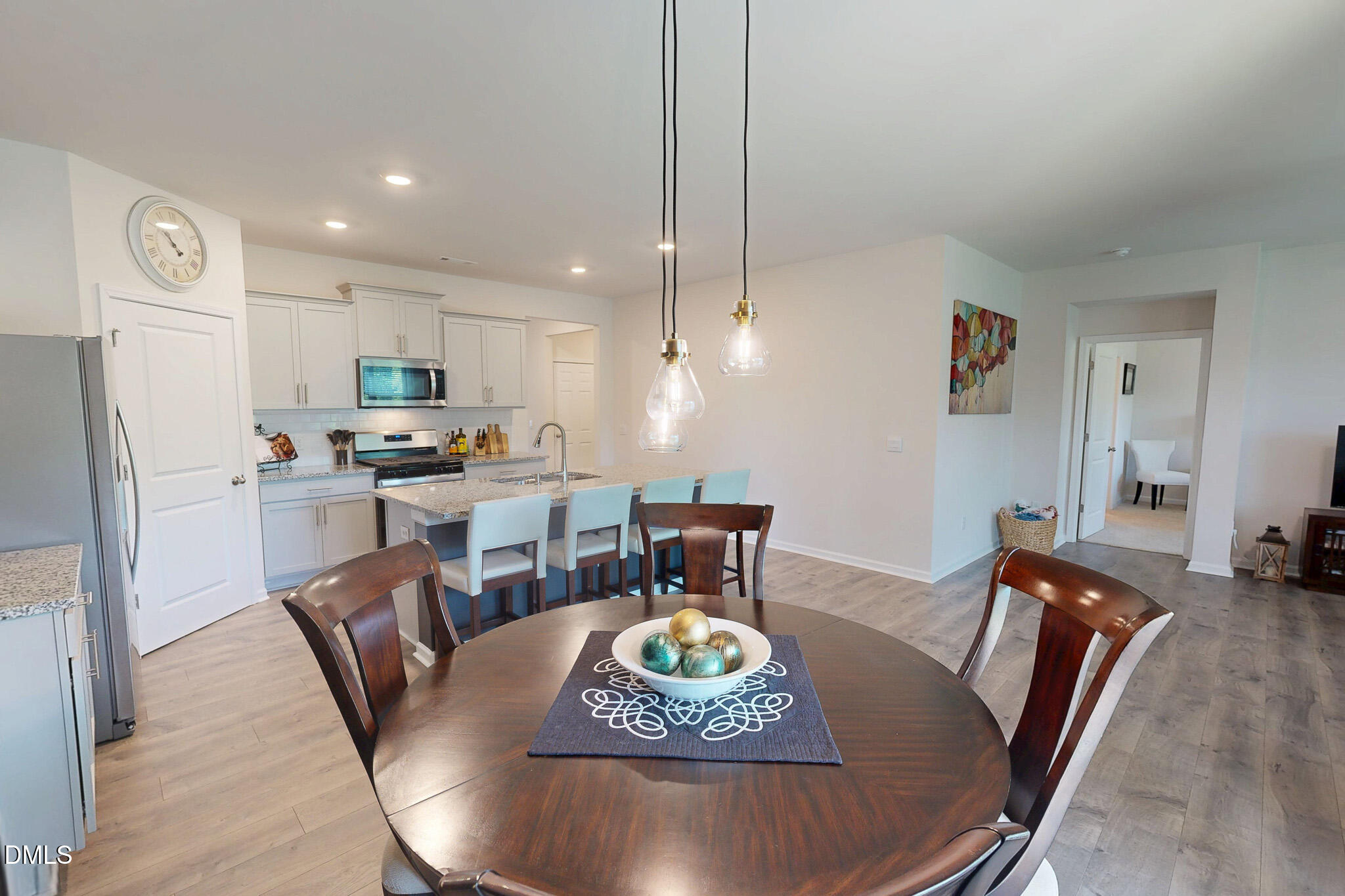 1017 Broadlands Way Graham, NC 27253 - Photo 11 of 32 a view of a dining room with furniture a kitchen and chandelier