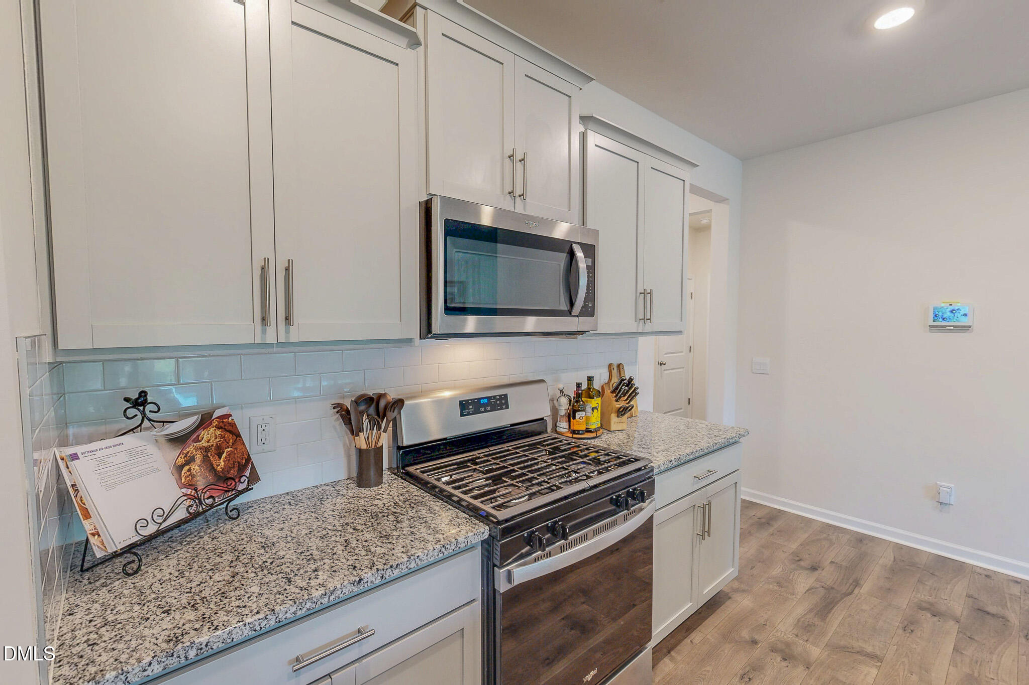 1017 Broadlands Way Graham, NC 27253 - Photo 13 of 32 a kitchen with granite countertop a stove a sink and a microwave