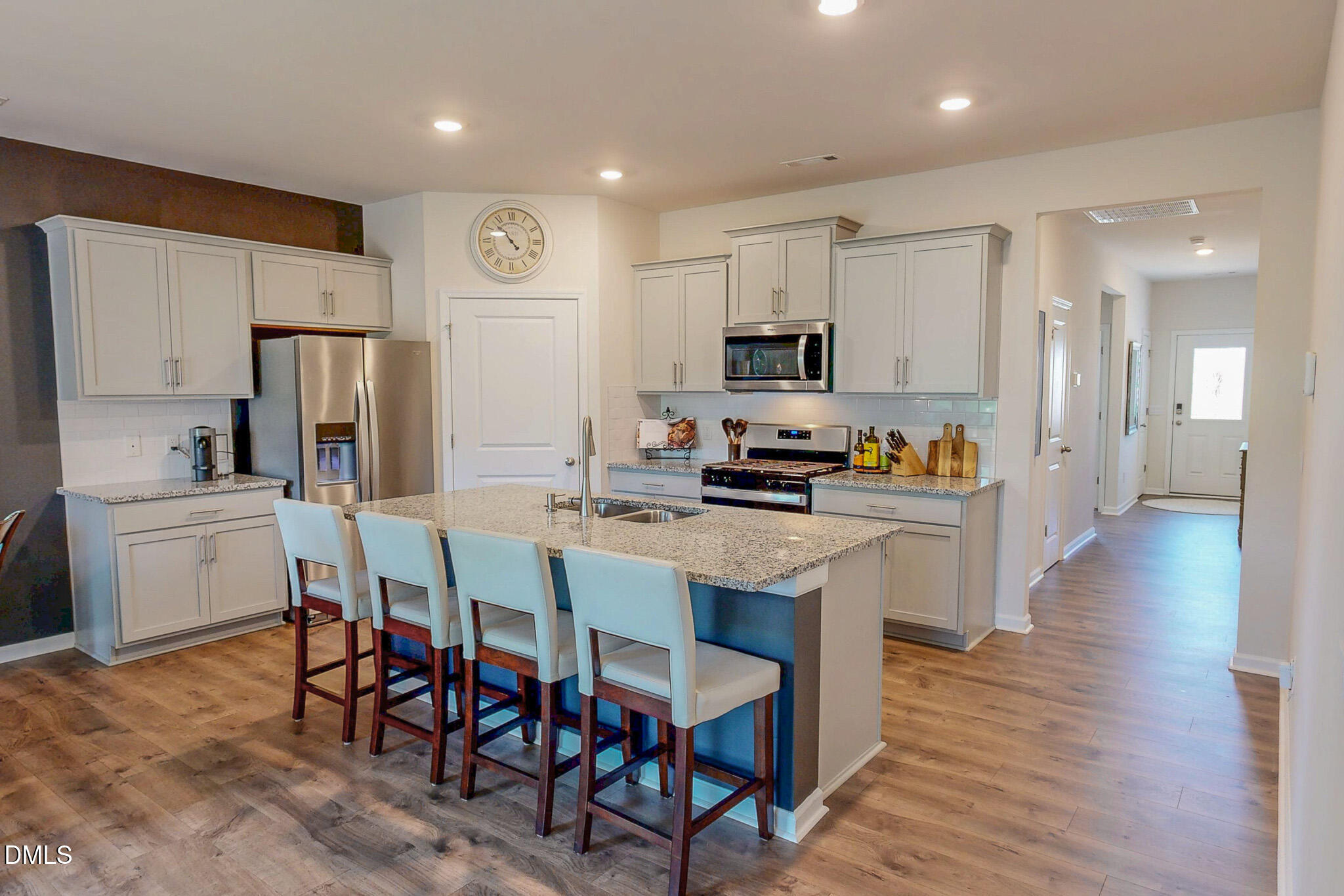 1017 Broadlands Way Graham, NC 27253 - Photo 14 of 32 a kitchen with stainless steel appliances a refrigerator a stove top oven and a center island with wooden floor