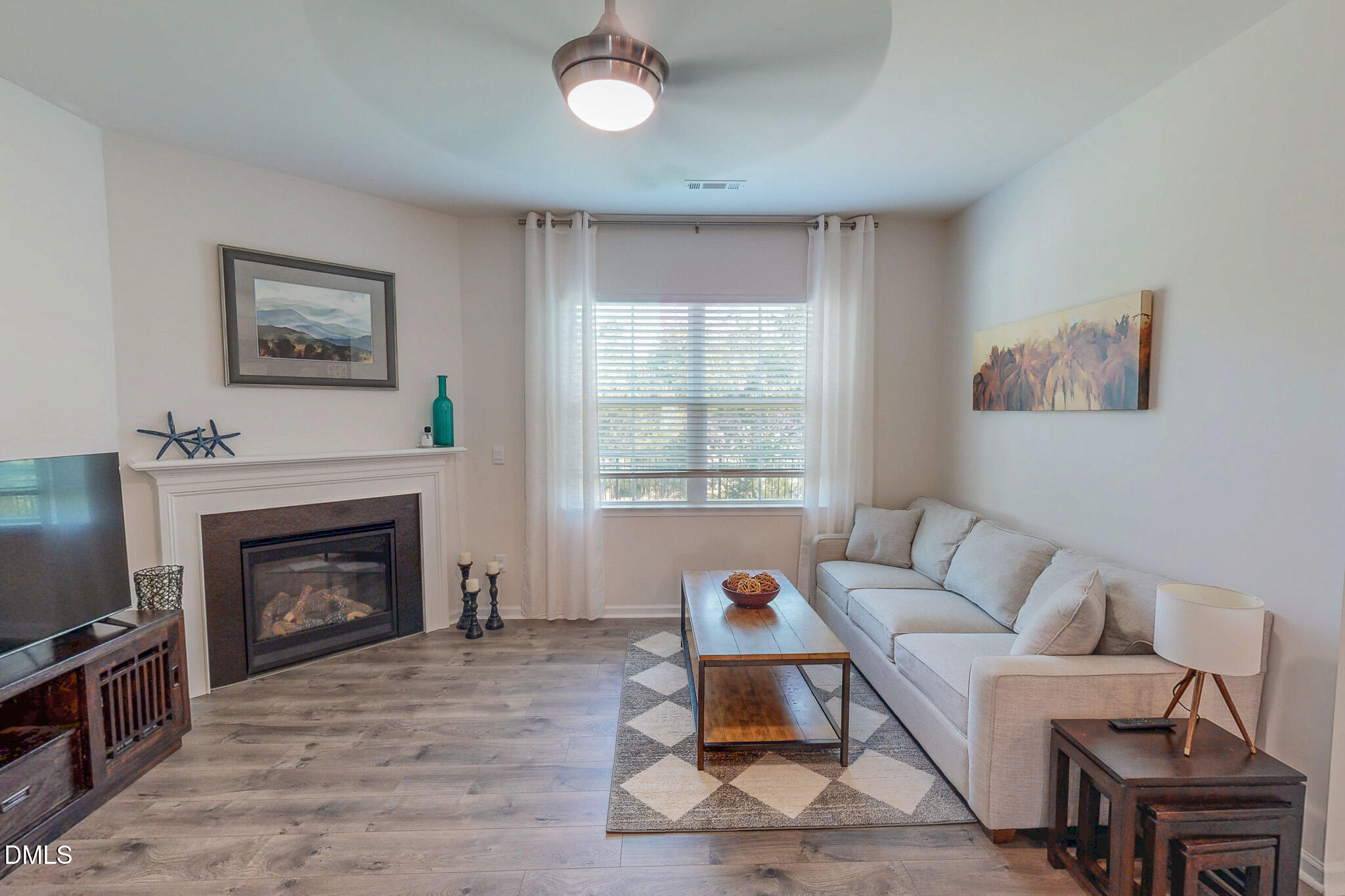 1017 Broadlands Way Graham, NC 27253 - Photo 3 of 32 a living room with furniture a window and a fireplace