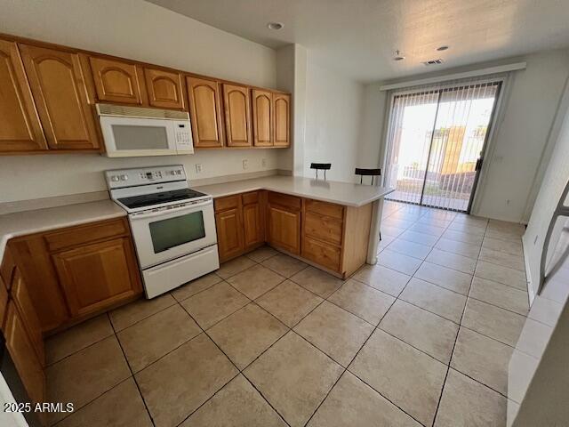 5415 East McKellips Road, Unit 31 Mesa, AZ 85215 - Photo 3 of 16 a kitchen with stainless steel appliances granite countertop a stove a sink and a microwave