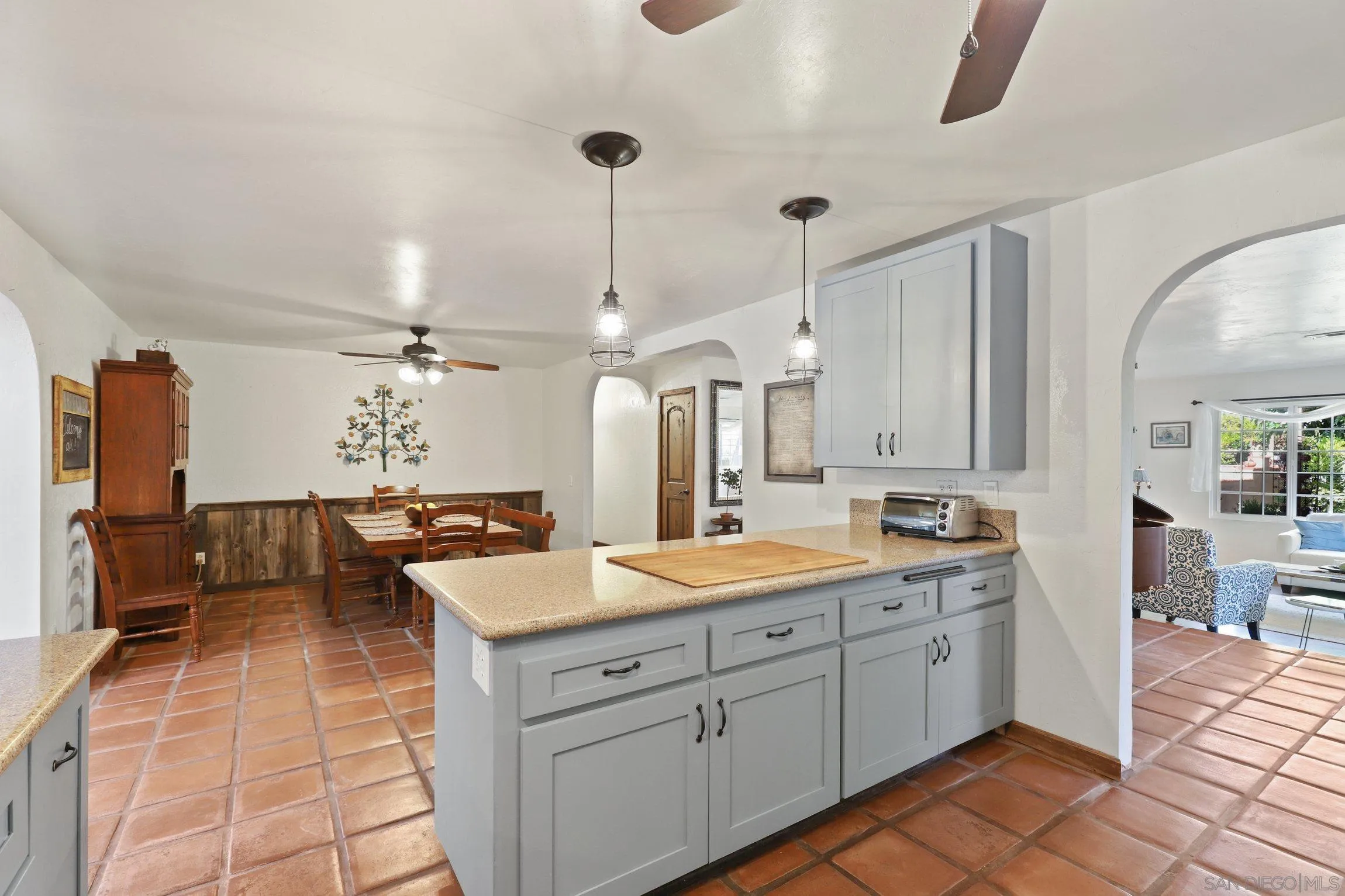 13107 Sudan Road Poway, CA 92064 - Photo 13 of 59 a large white kitchen with a stove a sink a dining table and chair