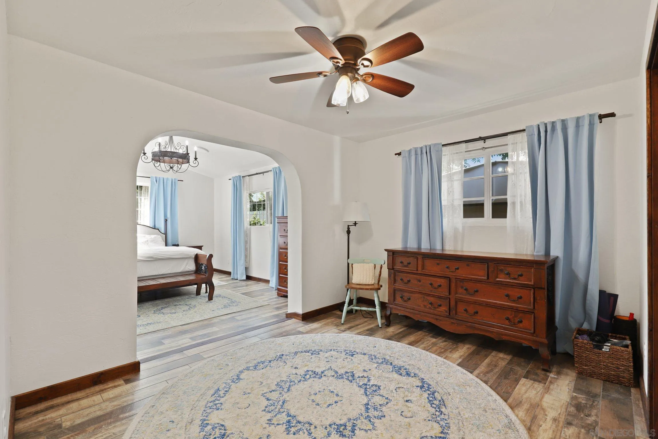 13107 Sudan Road Poway, CA 92064 - Photo 23 of 59 a spacious bedroom with a bed and a chandelier