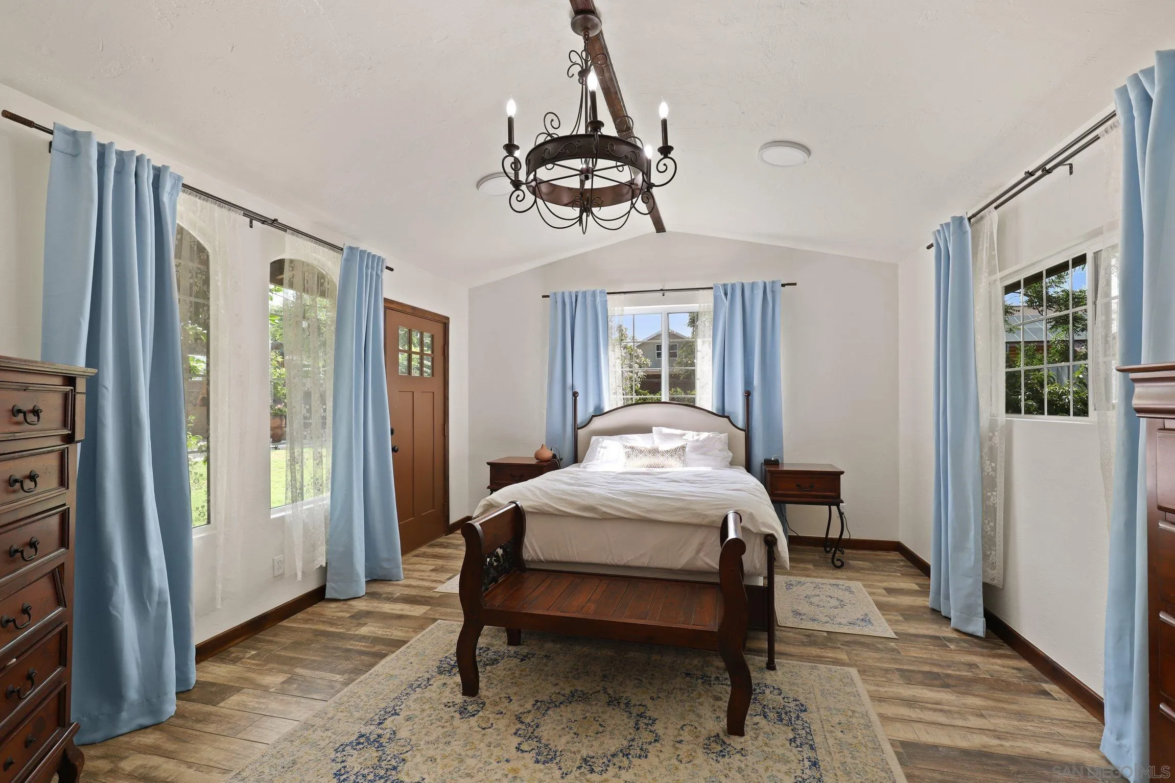 13107 Sudan Road Poway, CA 92064 - Photo 28 of 59 a bedroom with a bed a chandelier and mirror