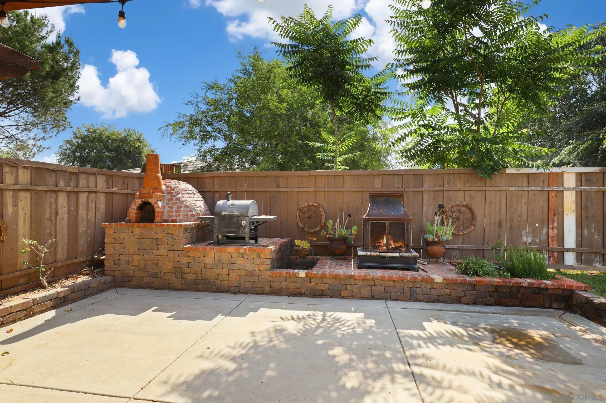 13107 Sudan Road Poway, CA 92064 - Photo 44 of 59 a view of a patio with table and chairs with wooden fence
