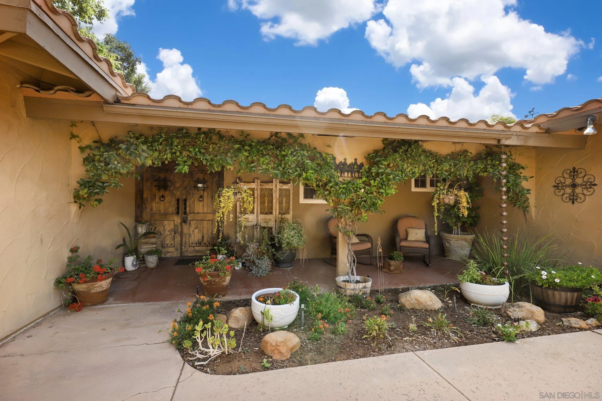 13107 Sudan Road Poway, CA 92064 - Photo 46 of 59 a view of a patio with table and chairs and potted plants